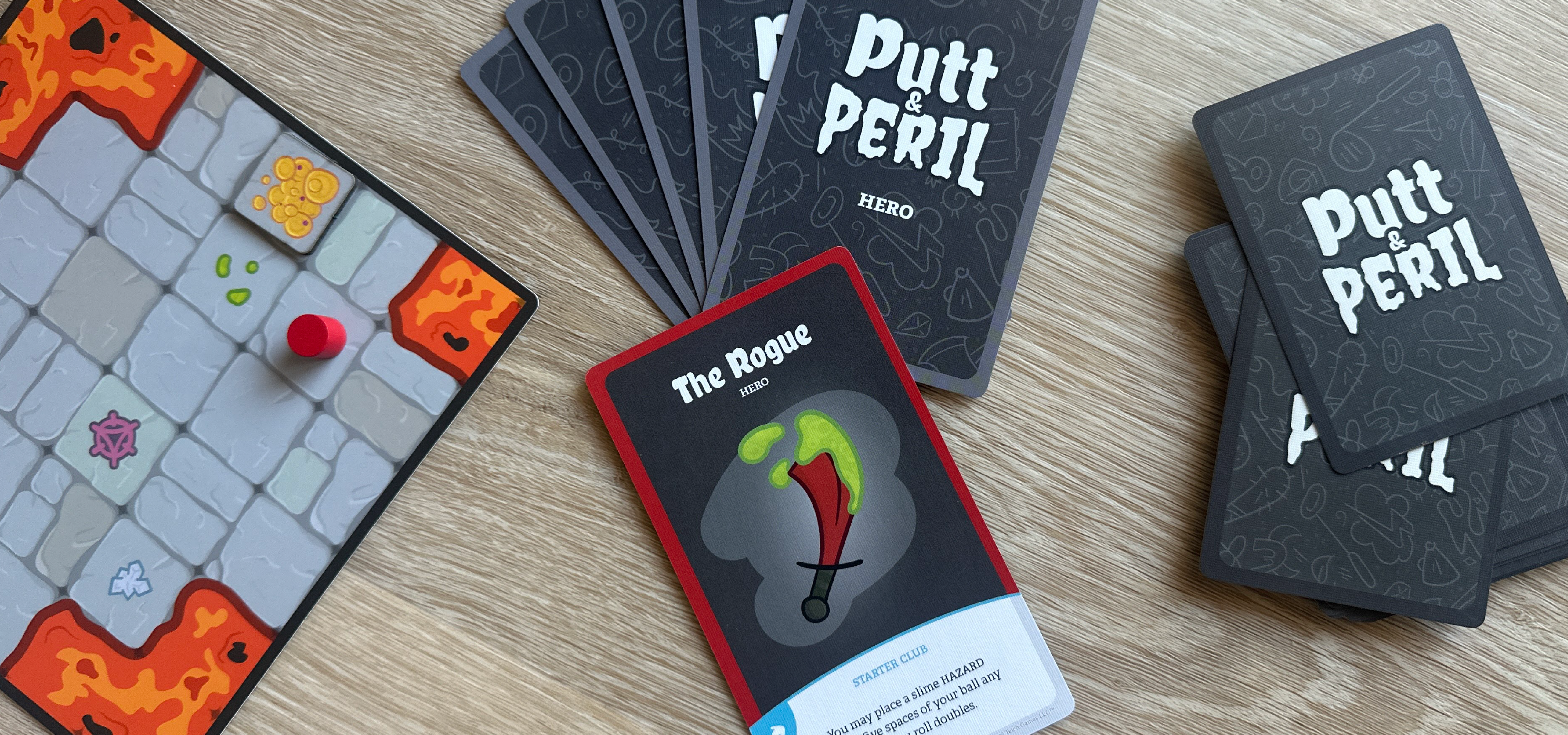 Game components thematically laid out featuring a card titled The Rogue